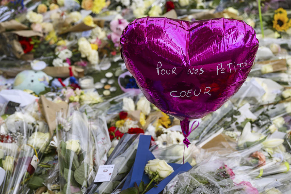 Flowers are laid down at a children's playground in Annecy, France, Saturday, June 10, 2023 following a knife attack on Thursday, June 8, 2023. French judges have handed preliminary charges of attempted murder to a man suspected of stabbing four young children and two adults in a French Alps park. The suspect is a 31-year-old Syrian refugee with permanent residency in Sweden. (Jean-Christophe Bott/Keystone via AP)