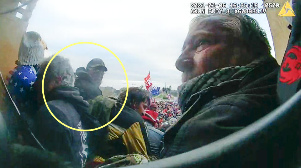 This image from police body-worn video, released and annotated by the Justice Department in the sentencing memo for Bernard Joseph Sirr, shows Sirr, circled in yellow, at the U.S. Capitol on Jan. 6, 2021, in Washington. Sirr, a Proud Boys extremist group member from Rhode Island, was sentenced on May 23, 2023, to two months of imprisonment for his role in the Jan. 6 riot. U.S. District Judge Trevor McFadden also sentenced Sirr to six months of home confinement and one year of probation, according to court records. (Justice Department via AP)