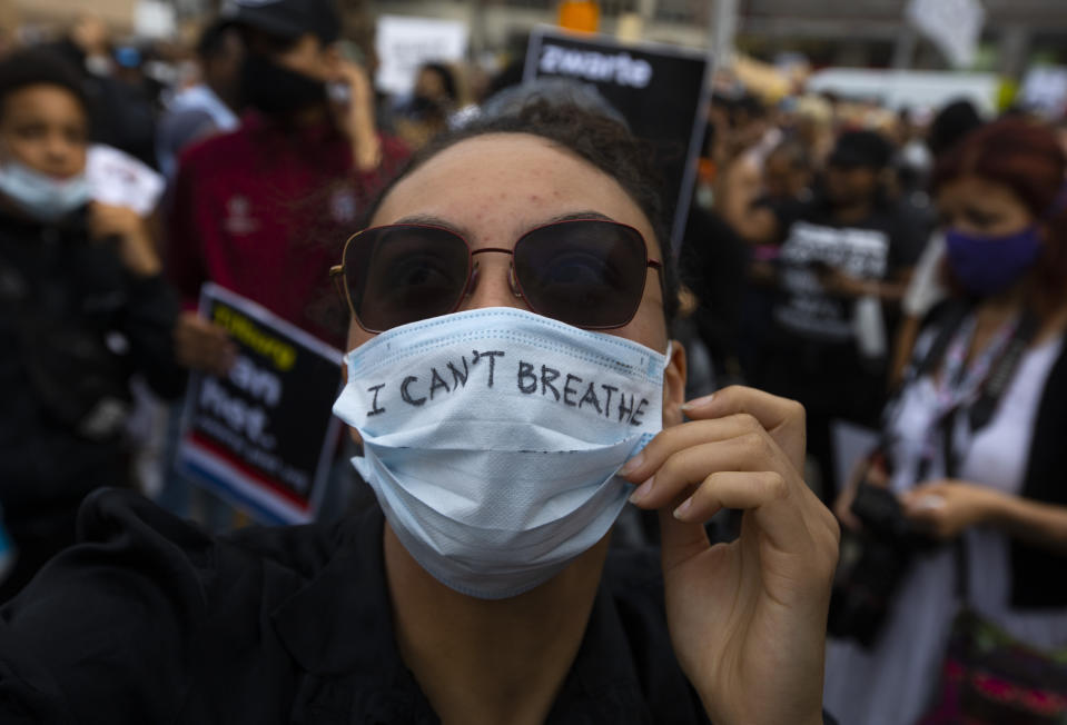 People take part in a Black Lives Matter protest in Amsterdam, Netherlands, Monday, June 1, 2020, to protest against the recent killing of George Floyd, a black man who died in police custody in Minneapolis, U.S.A., after being restrained by police officers on Memorial Day. (AP Photo/Peter Dejong)