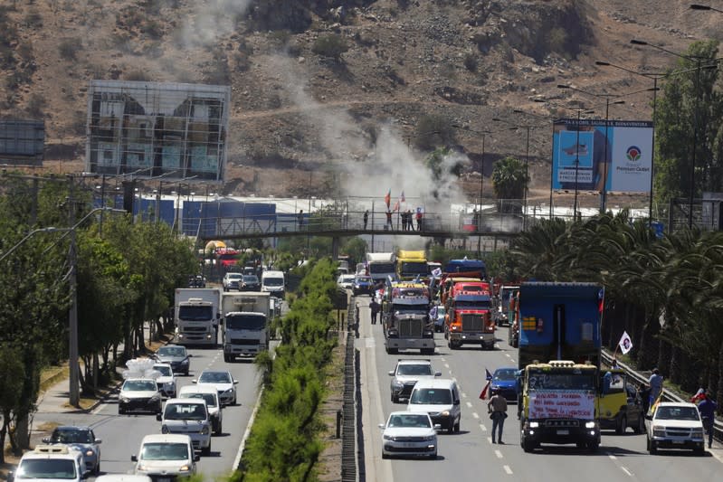 People block the road during a protest against the road tolls in the outskirts of Santiago