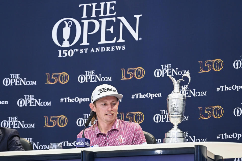Cameron Smith (pictured) looks at the Claret Jug trophy during a press conference.