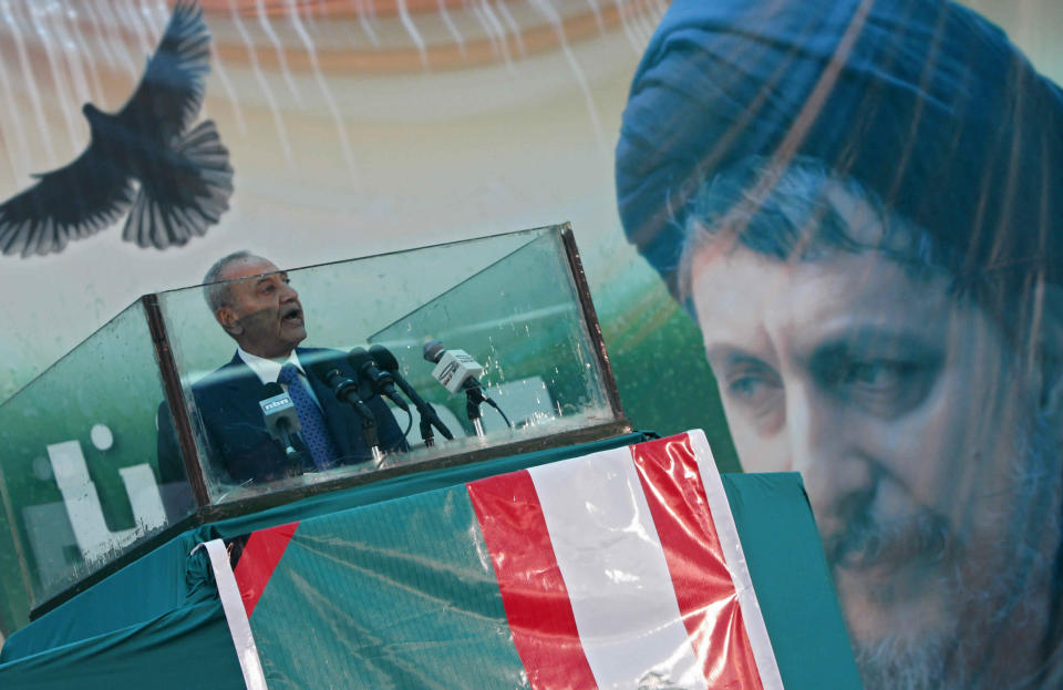 FILE -- In this August 31, 2009 file photo, Lebanese Parliament Speaker Nabih Berri delivers a speech in the southern suburbs of Beirut, Lebanon, during the 31st anniversary of the disappearance of the Shiite Muslim spiritual leader, Imam Moussa Sadr, seen in the picture at right, who disappeared on a trip to Libya in 1978. An Arab economic development summit that Lebanon is hosting this weekend has been marred by controversy days before delegates arrive. One issue is should Libya get a seat at the table, despite the unresolved mystery surrounding the disappearance of Sadr in Libya four decades ago? (AP Photo/Bilal Hussein, File)