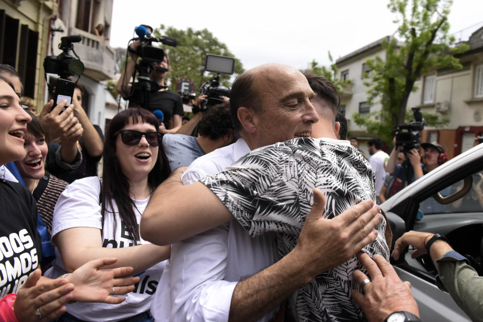 Daniel Martinez, presidential candidate for the ruling Broad Front party, is embraced by a supporter after voting in Montevideo, Uruguay, Sunday, Oct. 27, 2019. Fifteen years of leftist rule hangs in the balance as Uruguay faces a tight presidential election that is likely to head to a runoff vote. (AP Photo/Matilde Campodonico)