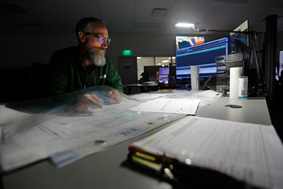 Steve Everett, Cape and Vineyard dispatcher, reviews some schematics of a project happening in the Cape at the Eversource state-of-the-art control center at their facility in the New Bedford industrial park.