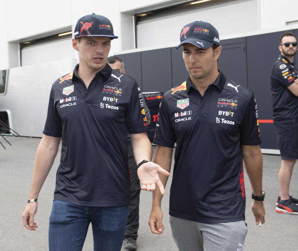 Red Bull drivers Max Verstappen, left, and Sergio Perez chat as they walk through the paddock at the Formula 1 Canadian Grand Prix auto race, Thursday, June 16, 2022 in Montreal. (Graham Hughes/The Canadian Press via AP)