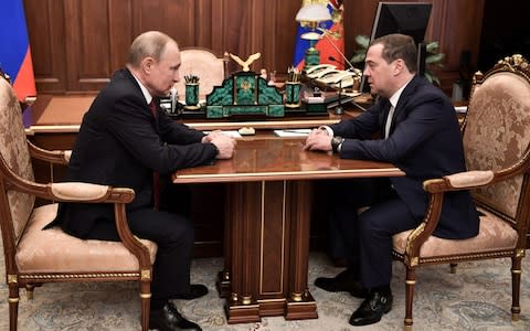 Russian President Vladimir Putin meets with Prime Minister Dmitry Medvedev in Moscow on Wednesday - Credit: ALEXEY NIKOLSKY/AFP