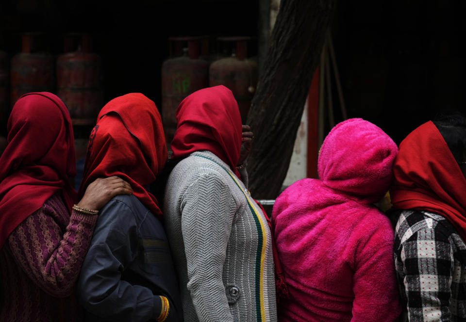 Nepalese people queue up to get vaccinated after government made vaccination cards mandatory for people to access public services in Kathmandu, Nepal, Thursday, Jan. 20, 2022. (AP Photo/Niranjan Shrestha)