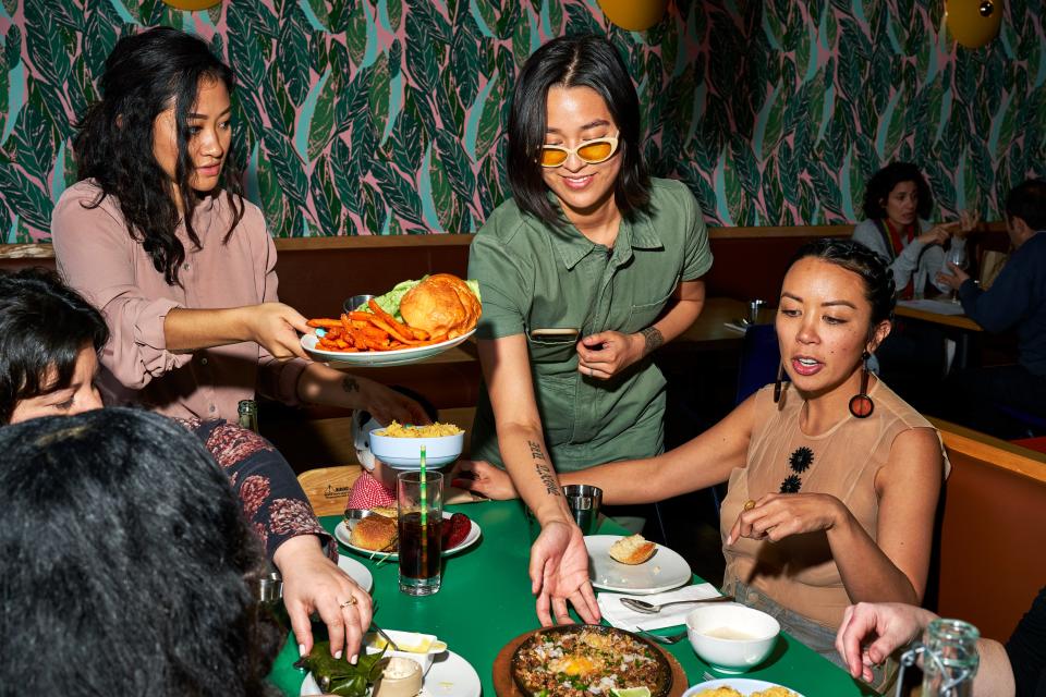 A party receives Ma'am Sir's sizzling sisig and fried-chicken sandwich.