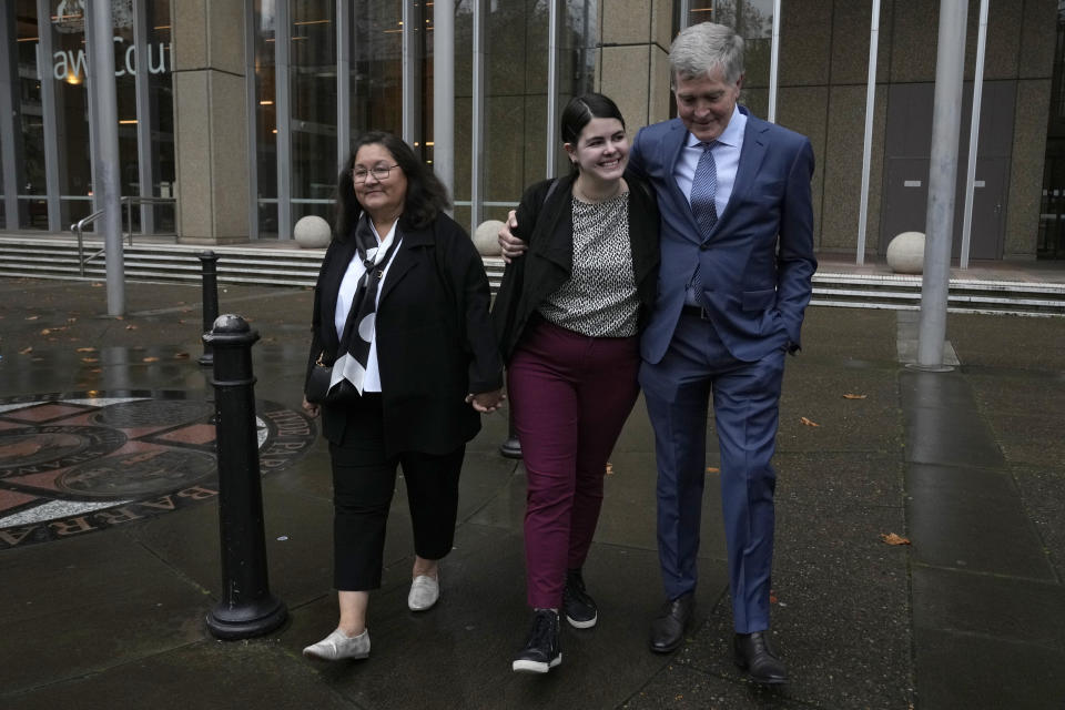 Steve Johnson, right, the brother of Scott Johnson, walks with his wife Rosemarie, left, and daughter Tessa outside the New South Wales Supreme Court in Sydney, Thursday, June 8, 2023. Scott Phillip White, the man who admitted killing American mathematician Scott Johnson by punching him from a cliff top at a gay meeting place in Sydney in 1988 was sentenced to nine years in prison. (AP Photo/Rick Rycroft)