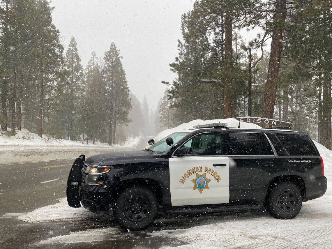 A CHP officer patrols Highway 168 near Camp Edison at Shaver Lake in eastern Fresno County, California, on Thursday, March 9, 2023. The CHP reported snow was sticking on the highway in that area as of 5:15 p.m. while it was raining on the lower section of the highway, on the four-lane above Prather.