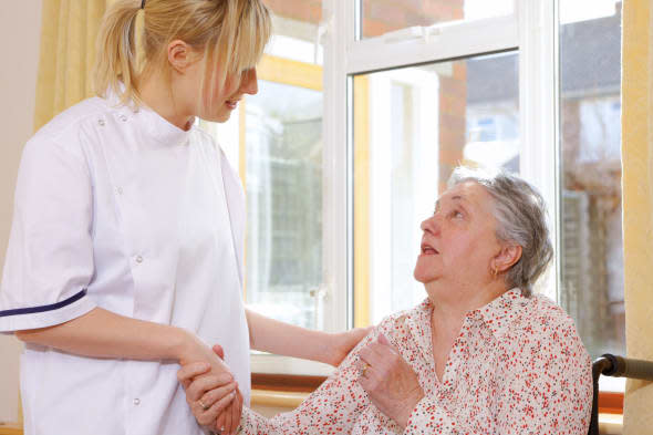 BCBW2Y care worker chatting to her elderly patient age; aged; care; carer; caucasian; commitment; committed; disability; disable