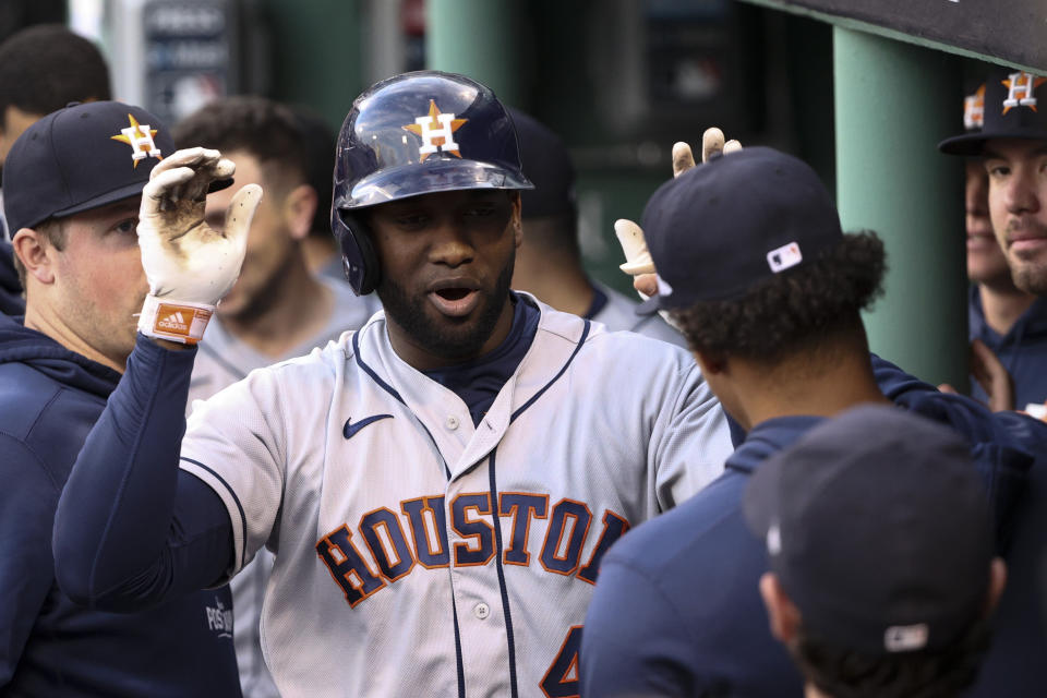 Houston Astros' Yordan Alvarez celebrates in the dugout after a home run against the Boston Red Sox during the second inning in Game 5 of baseball's American League Championship Series Wednesday, Oct. 20, 2021, in Boston. (AP Photo/Winslow Townson)