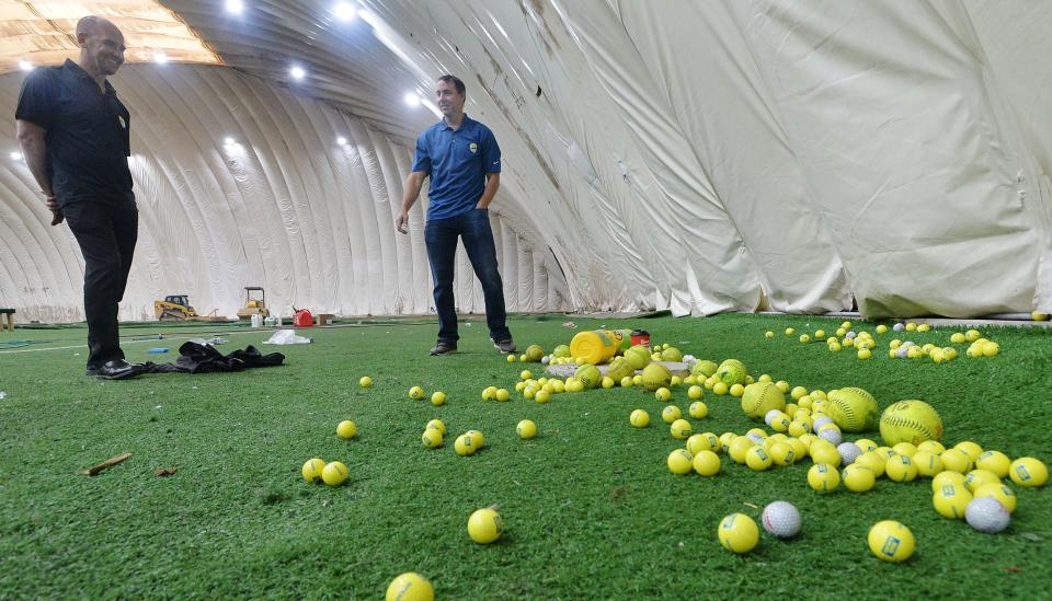 Business partners Troy Bingham, at left, and Sheldon van Deventer describe all of the stray balls found inside the former golf dome once owned by ErieBank Sports Park.