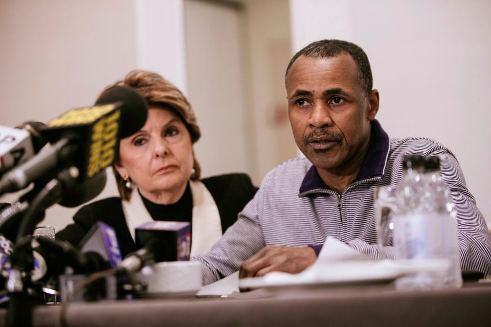 Gary Dennis, seated with lawyer Gloria Allred, speaks during a news conference.