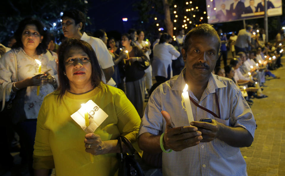 Pro- democratic Sri Lankans take part in a candle light vigil in Colombo, Sri Lanka, Sunday, Nov. 11, 2018. The crowd demanded the restoration of democracy after President Maithripala Sirisena dissolved Parliament and called for fresh elections. (AP Photo/Eranga Jayawardena)