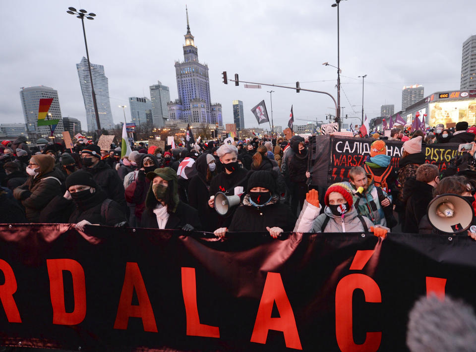 People demonstrate against police violence and an attempted restriction on abortion rights in Warsaw Poland, Saturday, Nov. 28, 2020. Nationwide protests Saturday were scheduled to coincide with Polish women gaining the right to vote 102 years ago. Weeks of protests against a high court's ruling to further restrict Abortion rights have evolved into the largest protest movement since communism fell 30 years ago.(AP Photo/Czarek Sokolowski)