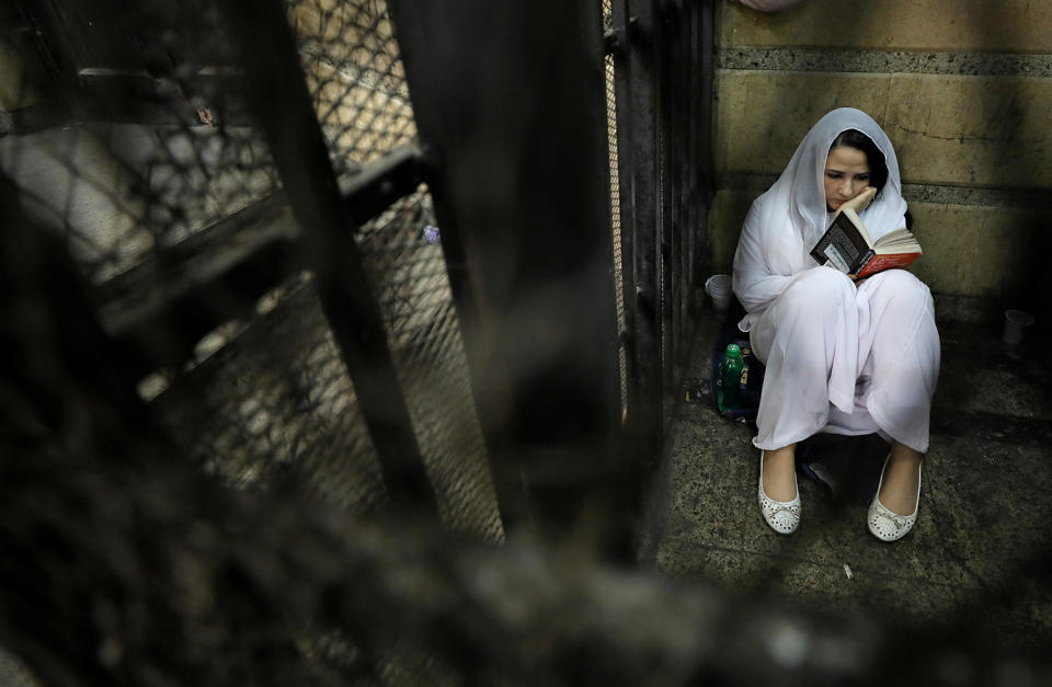 Woman reading a book inside holding cell