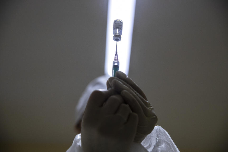 FILE - In this Wednesday, Dec. 30, 2020 file photo, a medical worker prepares a shot of Russia's Sputnik V coronavirus vaccine in Moscow, Russia. Russian scientists say the country's Sputnik V vaccine appears safe and effective against COVID-19, according to early results of an advanced study published on Tuesday Feb. 2, 2021, in a British medical journal. (AP Photo/Pavel Golovkin, File)