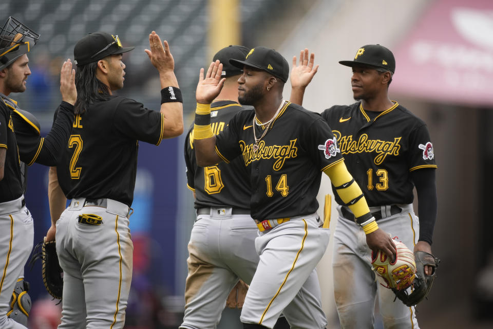Pittsburgh Pirates second baseman Rodolfo Castro is congratulated by teammates after the ninth inning of a baseball game against the Colorado Rockies Wednesday, April 19, 2023, in Denver. (AP Photo/David Zalubowski)