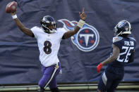Baltimore Ravens quarterback Lamar Jackson (8) celebrates after scoring a touchdown on a 48-yard run against the Tennessee Titans in the first half of an NFL wild-card playoff football game Sunday, Jan. 10, 2021, in Nashville, Tenn. At right is Titans cornerback Kristian Fulton (26). (AP Photo/Mark Zaleski)