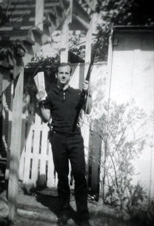 Lee Harvey Oswald, accused of assassinating former U.S. President John F. Kennedy, is pictured holding a rifle in this undated Dallas Police Department Archive image. REUTERS/Dallas Police Department