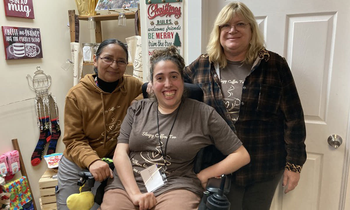 This is a photo of parent and board member Elvira Juarez, employee Hillary Barber and Sleepy Coffee, Too founder and retired special education teacher Kim Kaczmarek at the Sleepy Hollow.