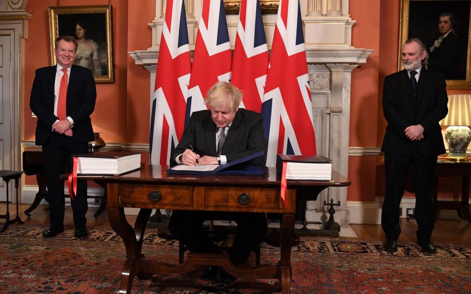 Lord Frost, pictured far left, watches on as Boris Johnson signs the Brexit trade deal - Getty