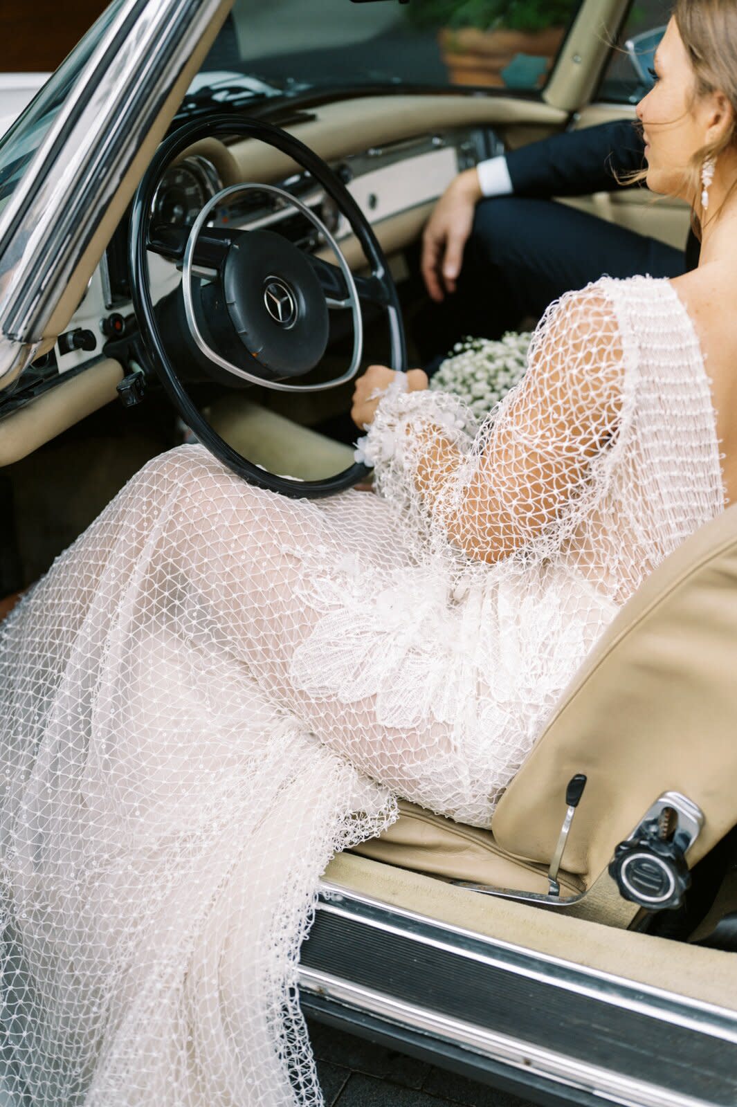 bride wearing long sleeve netted lace mermaid wedding dress