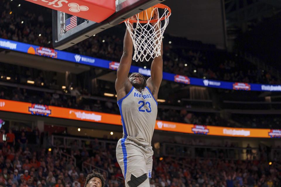 Memphis forward Malcolm Dandridge (23) dunks against Auburn during the second half of an NCAA college basketball game on Saturday, Dec. 10, 2022, in Atlanta. (AP Photo/Erik Rank)