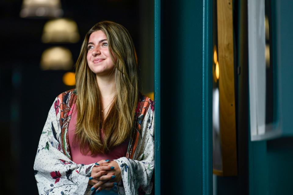 Anna Castro Spratt, 16, Greenville's first Youth Poet Laureate, poses for a portrait inside the Fine Arts Center at Wade Hampton High School on Wednesday, May 3, 2023.