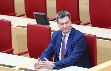 FILE PHOTO: New Bavarian State Prime Minister Markus Soeder taks his seat after his election in Munich, Germany, March 16, 2018.  REUTERS/Michael Dalder