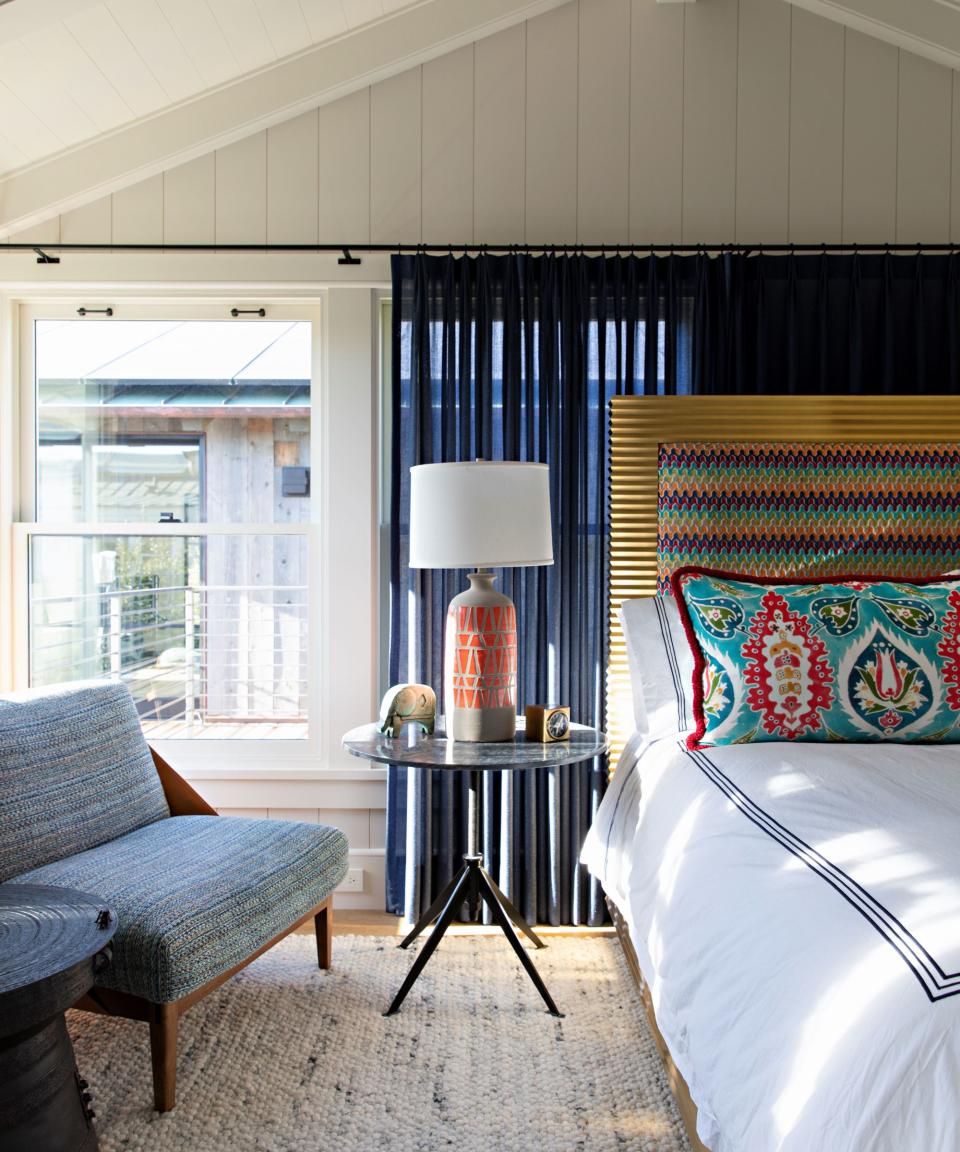 bedroom with colorful cushion and paneled walls