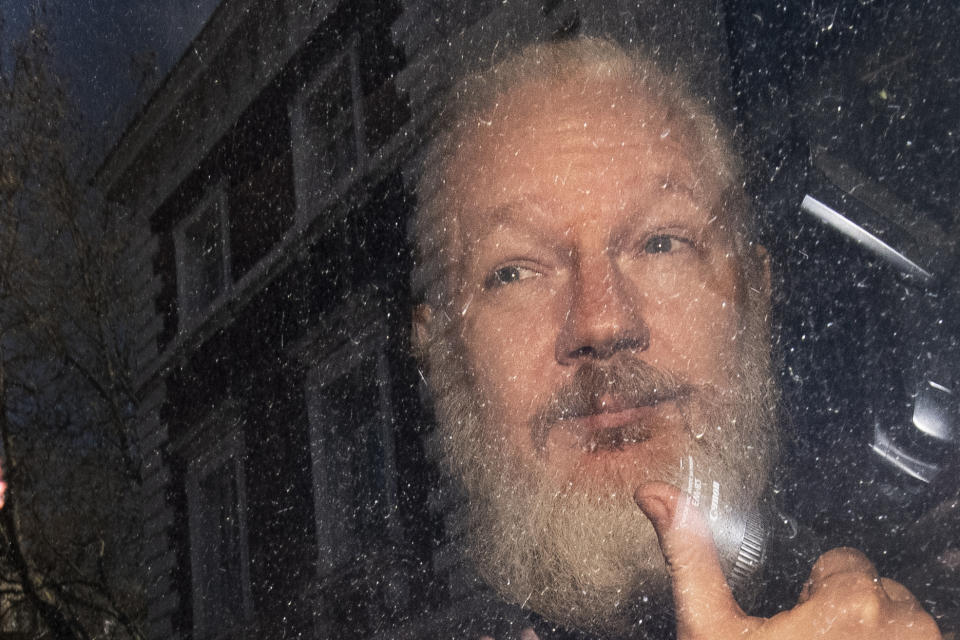 Julian Assange gestures as he arrives at Westminster Magistrates’ Court in London, after the WikiLeaks founder was arrested by officers from the Metropolitan Police and taken into custody Thursday April 11, 2019.(Victoria Jones/PA via AP)