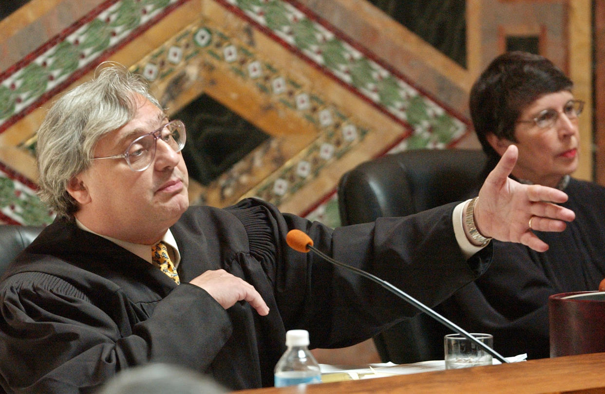 In this Sept. 22, 2003 file photo, Judge Alex Kozinski, of the 9th U.S. Circuit Court of Appeals, gestures as Chief Judge Mary Schroeder looks on in San Francisco. A decision by a divided three-judge panel of the 9th U.S. Circuit Court of Appeals in San Francisco on Wednesday, Feb. 16, 2014, reinstated a lawsuit filed against YouTube by an actress who appeared in an anti-Muslim film that sparked violence in many parts of the Middle East. The 9th Circuit said the YouTube posting infringed actress Cindy Lee Garcia&#39;s copyright to her role, and she, not just the filmmaker, could demand its removal. (AP Photo/Paul Sakuma, Pool, file)