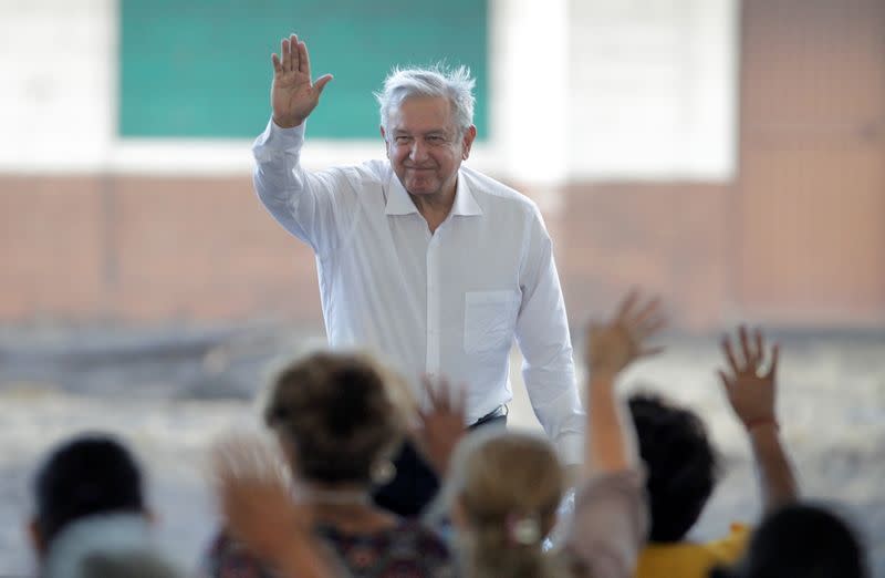 Mexico's President Andres Manuel Lopez Obrador waves during a meeting with relatives of the 65 miners who died during an explosion at Pasta de Conchos coal mine, in San Juan de Sabinas