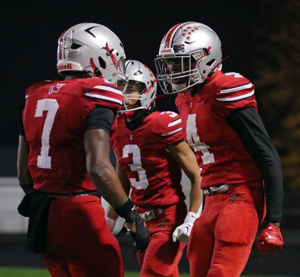 East wide receiver Luther Darisaw, right, celebrates his receiving touchdown with Ziaire Stevens, left, during the second half of a Division III playoff football game against Canfield on Friday in Akron.