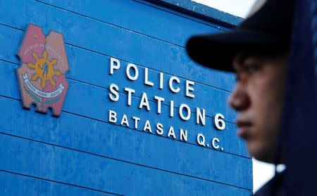 A policeman waits for the start of a flag-raising ceremony at the grounds of Station 6, Batasan Police Station, in Quezon City, Metro Manila, Philippines December 4, 2017. Picture taken December 4, 2017. To match Special Report PHILIPPINES-DRUGS/SQUAD REUTERS/Erik De Castro