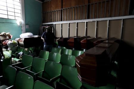 A volunteer rests in a church auditorium as they collect aid for mudslide victims in Santa Catarina Pinula, on the outskirts of Guatemala City, October 5, 2015. REUTERS/Jose Cabezas