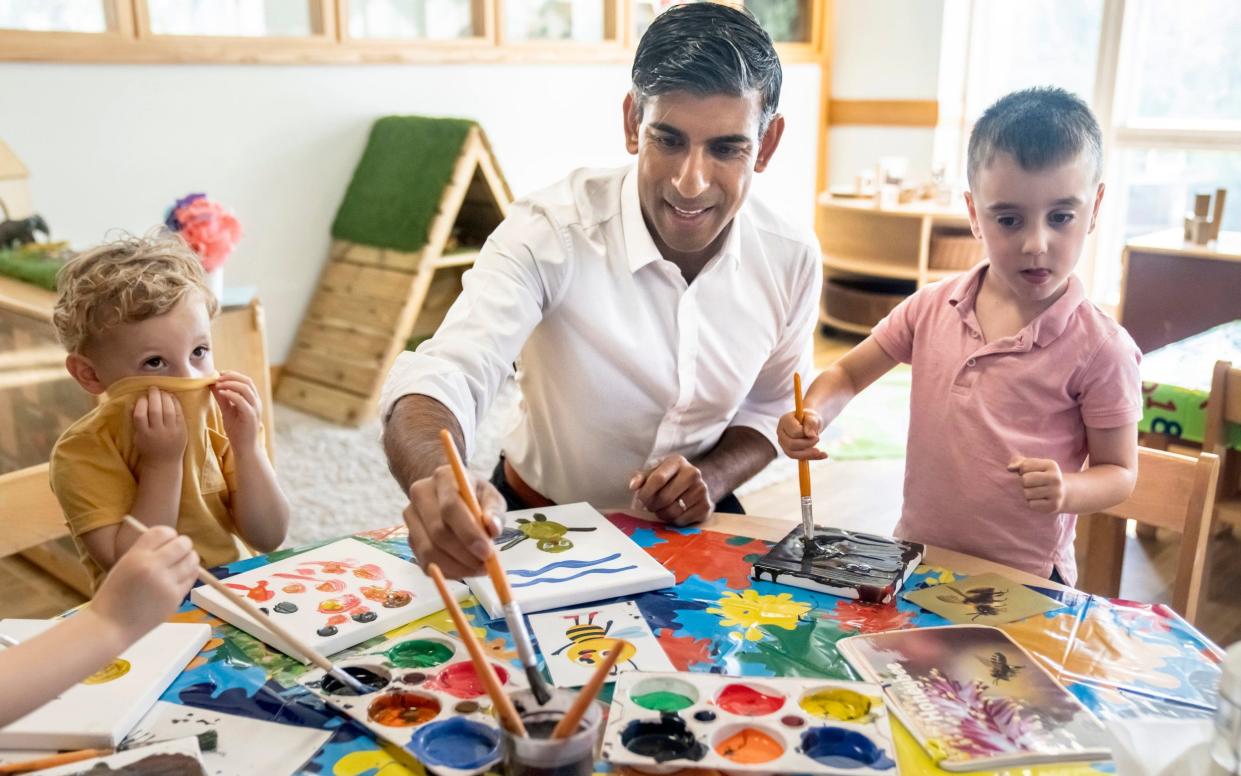 Prime Minister Rishi Sunak paints an image of a bee during a visit to the Busy Bees nursery in Harrogate, North Yorkshire