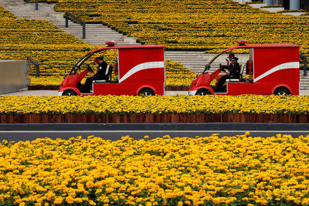 Firemen drive electric firetrucks at the National Exhibition and Convention Center, the venue for the upcoming China International Import Expo (CIIE), in Shanghai, China November 3, 2018. REUTERS/Aly Song