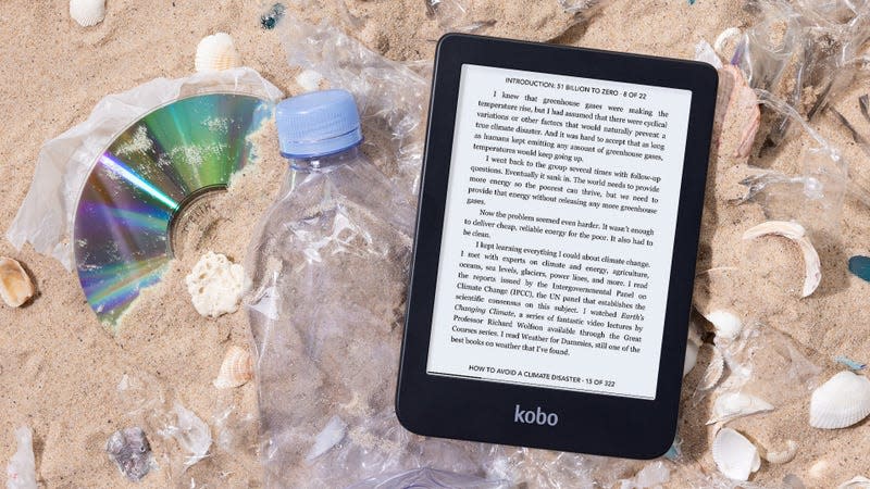 The Kobo Clara 2E sitting on a trash-covered beach.