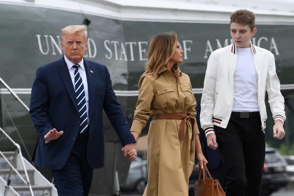 In this Aug. 16, 2020 file photo, President Donald Trump, first lady Melania Trump and their son, Barron Trump, walk off of Marine One and head toward Air Force One at Morristown Municipal Airport in Morristown, N.J.