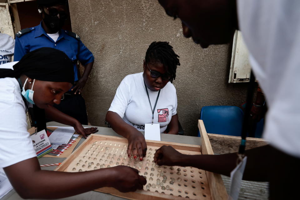 Gambian's polling station staff members count marbles that represent votes during the presidential election, in Banjul, Gambia December 4, 2021. REUTERS/Zohra Bensemra