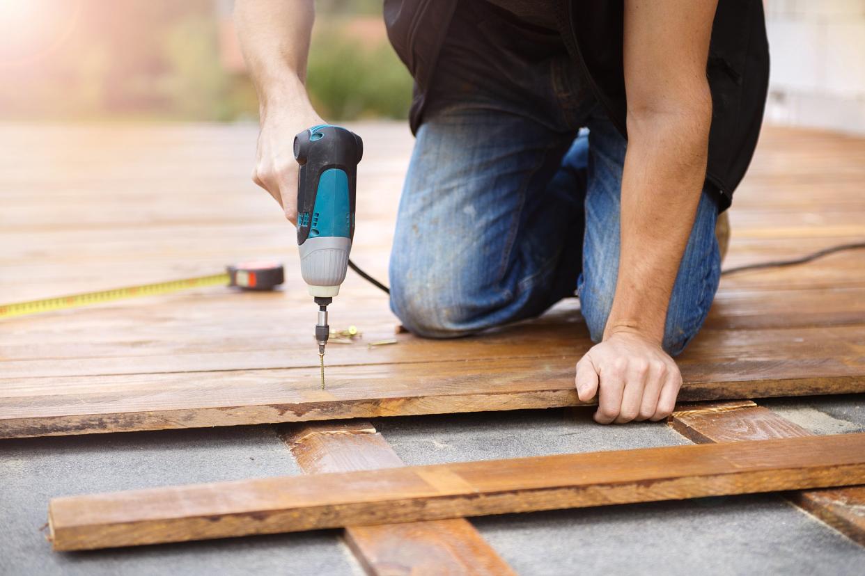 handyman installing wooden flooring