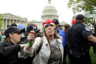 U.S. Capitol Hill police officers arrest protesters smoking marijuana on steps of the U.S. Capitol in Washington, U.S. April 24, 2017. REUTERS/Yuri Gripas