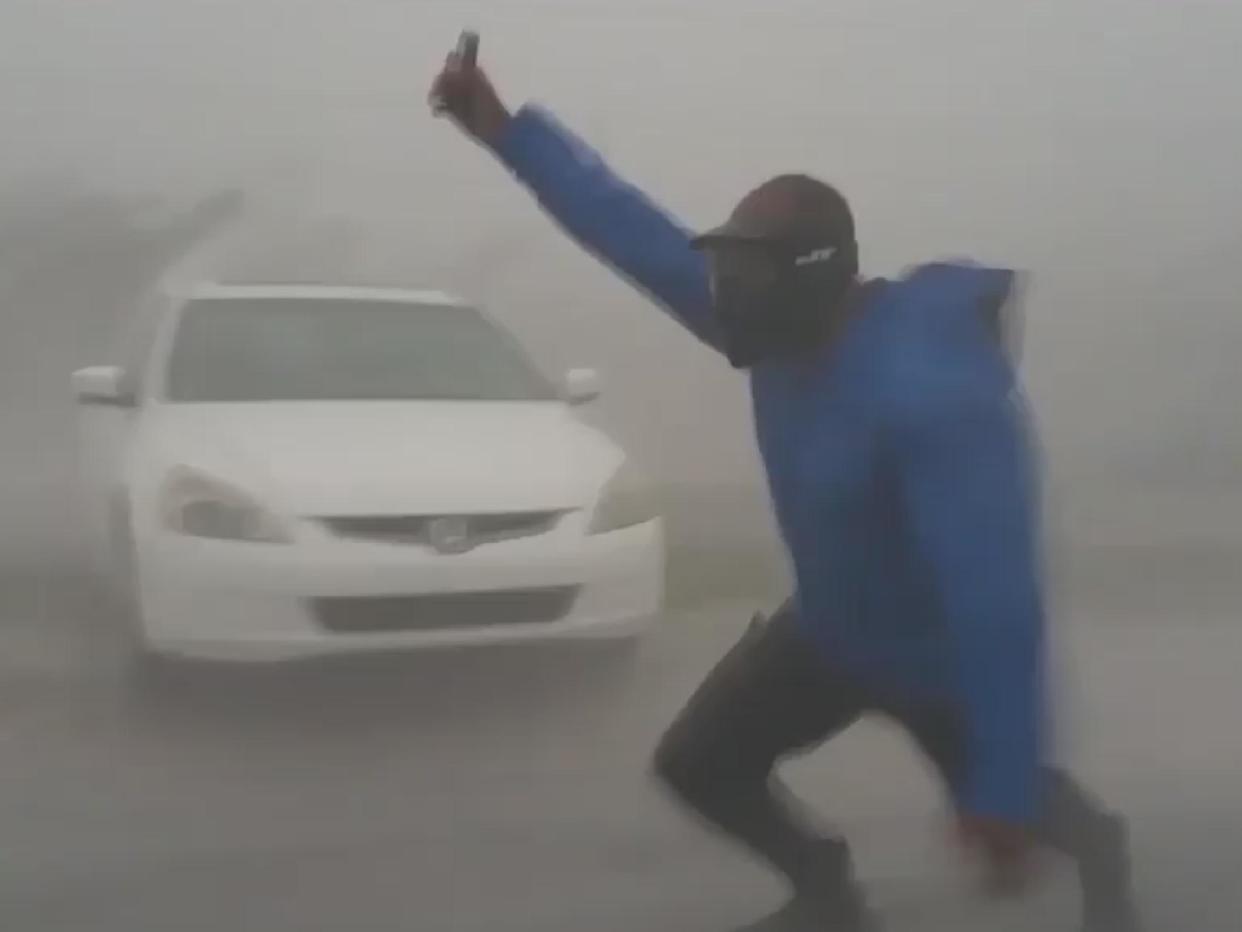 Juston Drake is seen struggling to walk in the strong winds: Screengrab