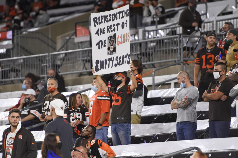 Cleveland Browns fans watch during the first half of an NFL football game between the Cleveland Browns and the Cincinnati Bengals, Thursday, Sept. 17, 2020, in Cleveland. (AP Photo/David Richard)