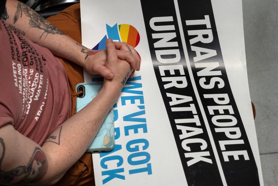 People gather at a rally protesting lawmakers gathering to override Gov. Eric Holcomb's veto of HB1941, Tuesday, May 24, 2022 at the Indiana Statehouse in Indianapolis, Ind.  Lawmakers later overrode Gov. Eric Holcomb's veto of HB 1041, the transgender sports ban.