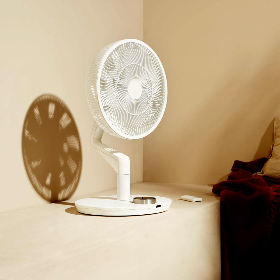 The white Duux Whisper Flex Ultimate Fan sat on a shelf