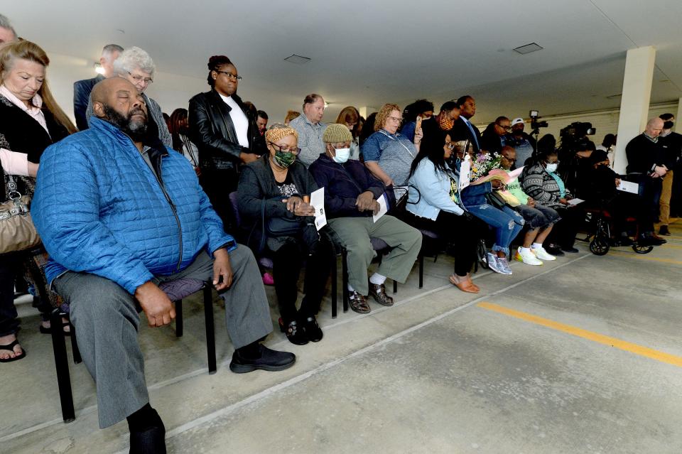 Family members of Department of Children and Family Service caseworker Deidre Silas, who was stabbed to death while doing her job, front, along with others attending the annual Workers Memorial Day ceremony at the Illinois AFL-CIO Front Plaza, observe a moment of silence Thursday. [Thomas J. Turney/The State Journal-Register]